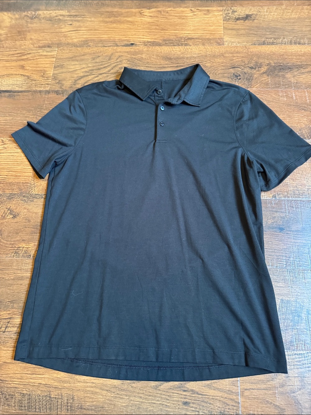 Men’s M Lululemon ABC polo shirt in a rich black color.